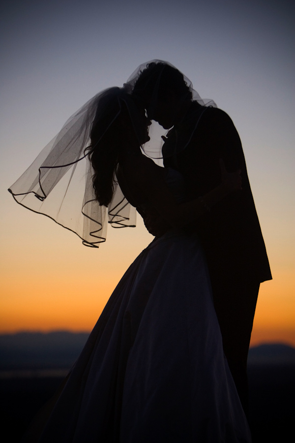 Bride and groom in silhoutte at sunset - wedding photo by J Garner Photographer